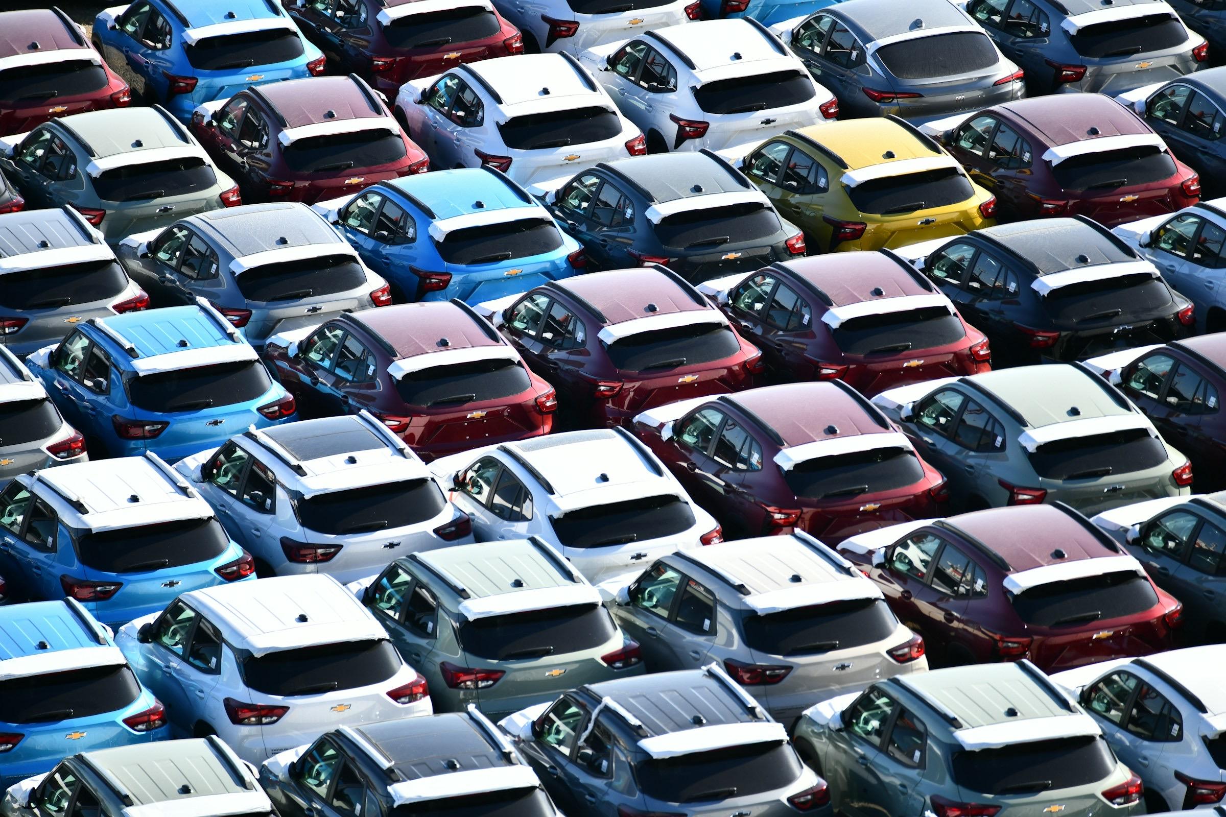Rows of new cars on a dealership lot